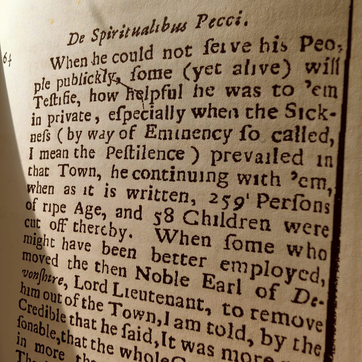 A close-up photograph of page 64 of William Bagshaw's 1702 book De Spiritualibus Pecci, the earliest surviving account of the plague in Eyam, describing the toll of 259 adults and 58 children.